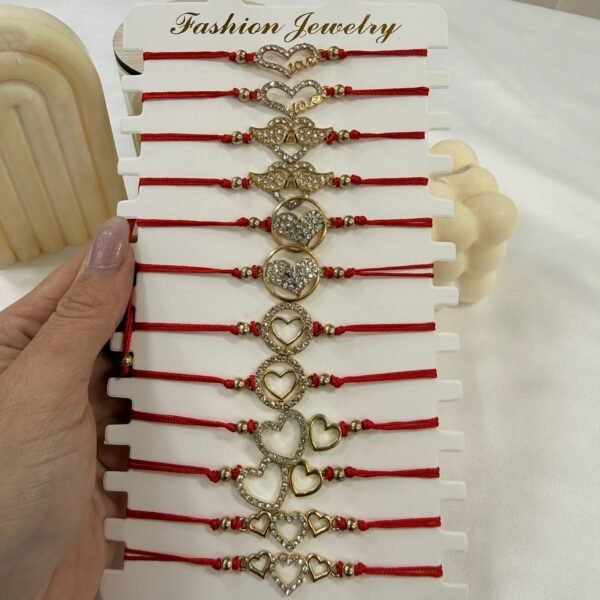 pulsera Van corazones hilo rojo modelos varios x 12 unidades